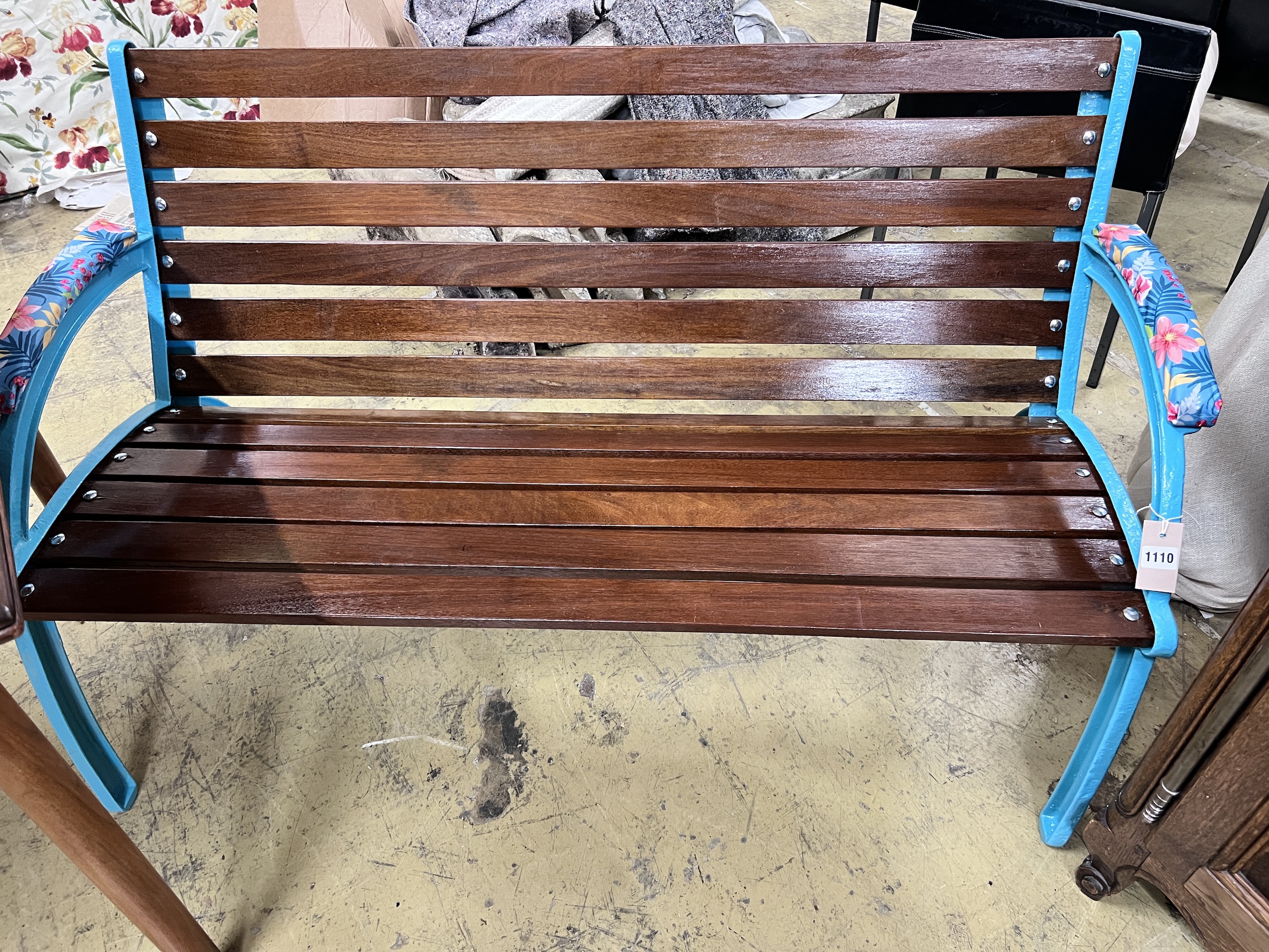 A teak and cast iron garden bench, length 127cm